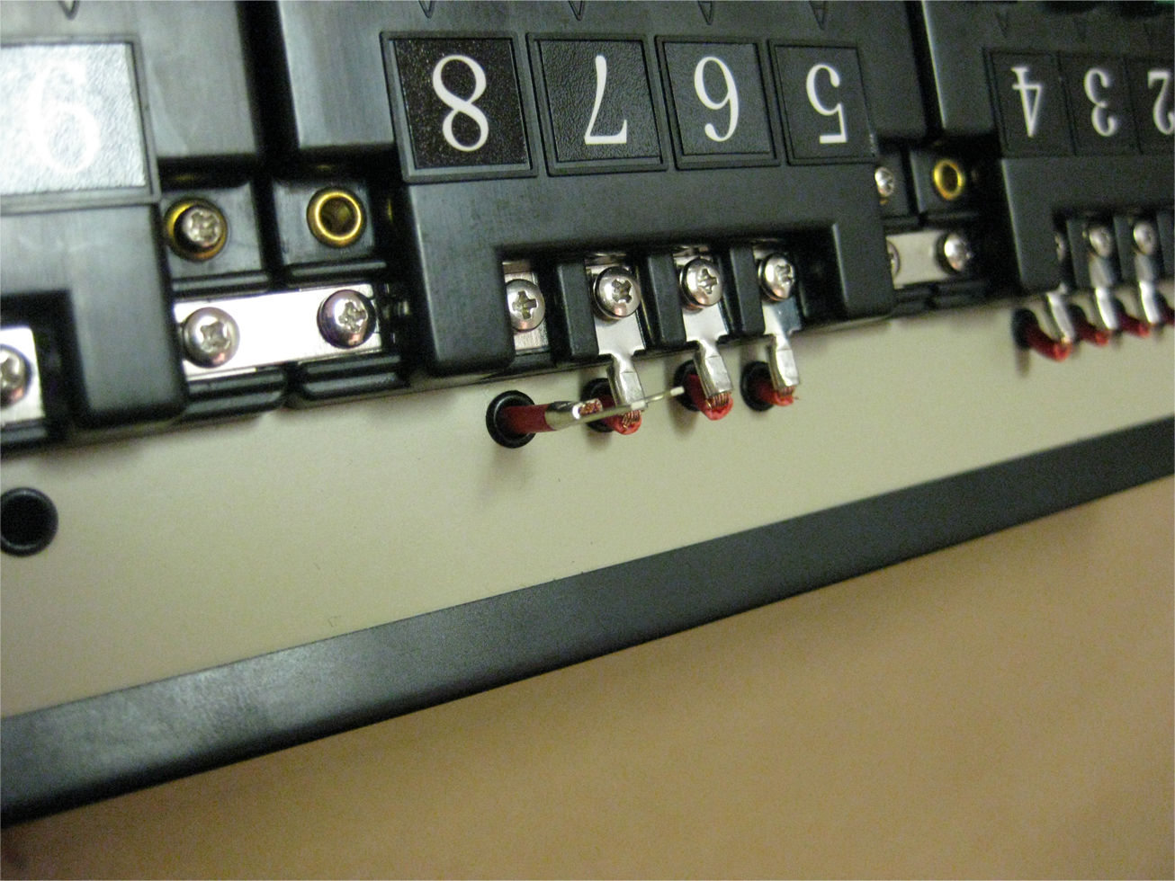 Power leads attached to Atlas selectors with terminal connectors on a model railroad control panel