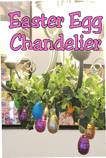 Take your Easter Egg hunt inside with this fun Easter decoration. It's so easy to decorate your dinning room chandelier with beautiful Easter eggs and greenery to make a stunning Easter Egg Chandelier that will bring some extra sparkle and shine to your Easter dinner. #easter #easterdecoration #diy #chandelier #diypartymomblog