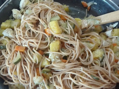 foto en la que añadimos los espaguetis al sofrito de calabacín, pollo y piña 