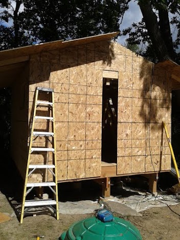 Sheathing the rest of the entry wall and the other side of the roof.