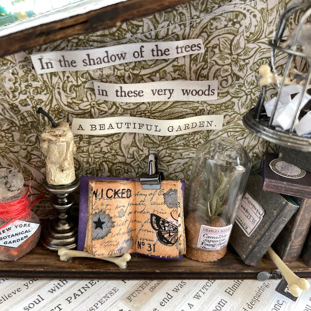 The Devious Botanist Halloween Vignette made with: Tim Holtz coffin vignette, backdrops, stickers, curiosities, curator labels, corked vials, corked domes, birdcage, toadstools, candle stands, drippy candles, bubbles, spider, hardware heads, tiny clips, mini books ephemera, villainous potion, mr. bones