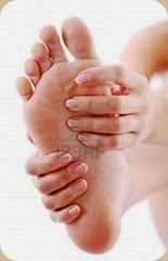 6606763-young-woman-massages-her-foot-on-a-white-background
