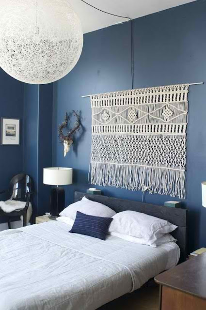 bedroom with blue wall and large macrame