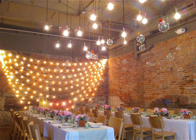 Zingerman's on fourth wedding reception hanging glass globe candles bud vases and wood box centerpieces by sweet pea floral design
