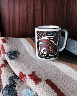 A vintage mug on a blanket