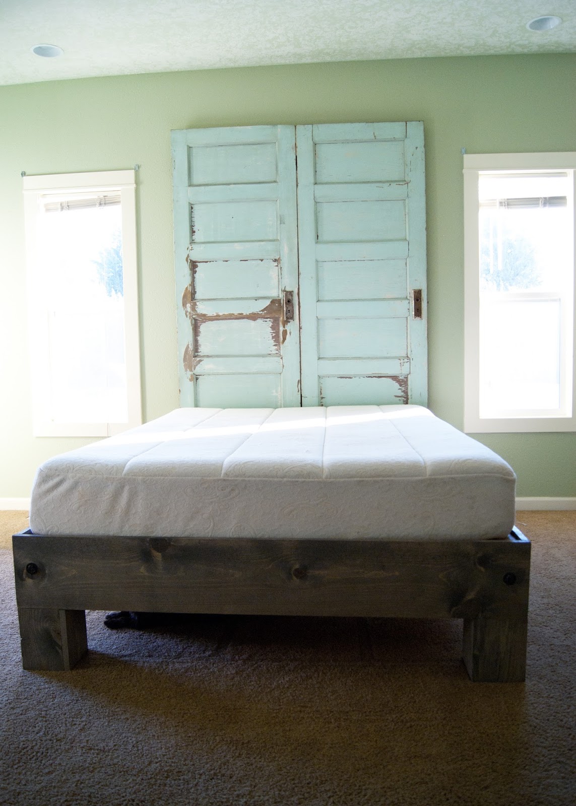 Platform bed and Old door headboard in mint green and weathered gray stain