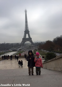 Children by the Eiffel Tower in the mist