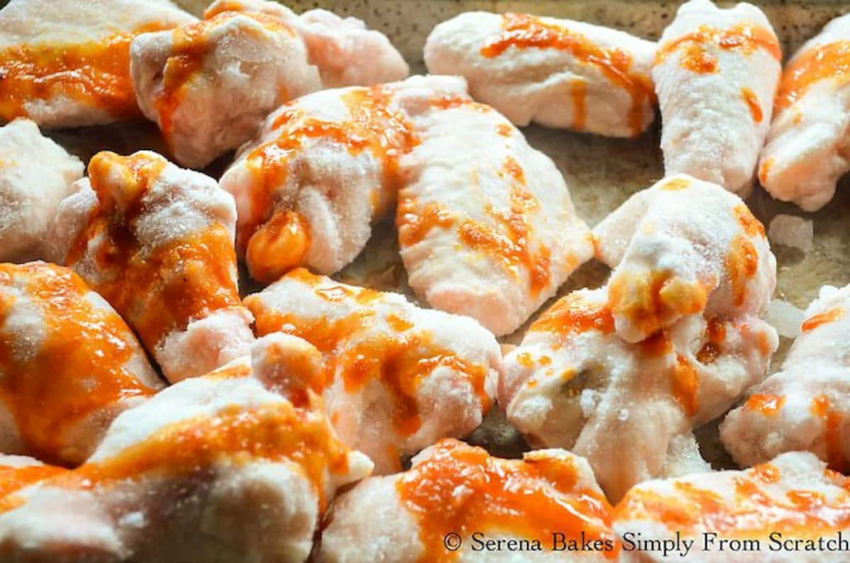 Frozen Chicken Wings with oil mixture drizzled over the top.