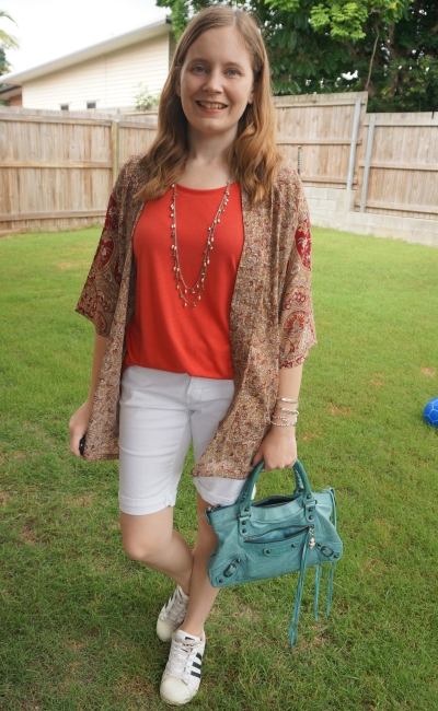 gold and burgundy silk kimono with red tee and white Bermuda denim shorts turquoise Balenciaga bag | away from blue