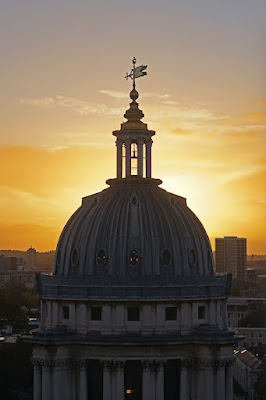 Painted Hall dome outlined against an orange sunset.