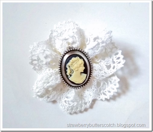 Close up of the cameo lace rosette broach.