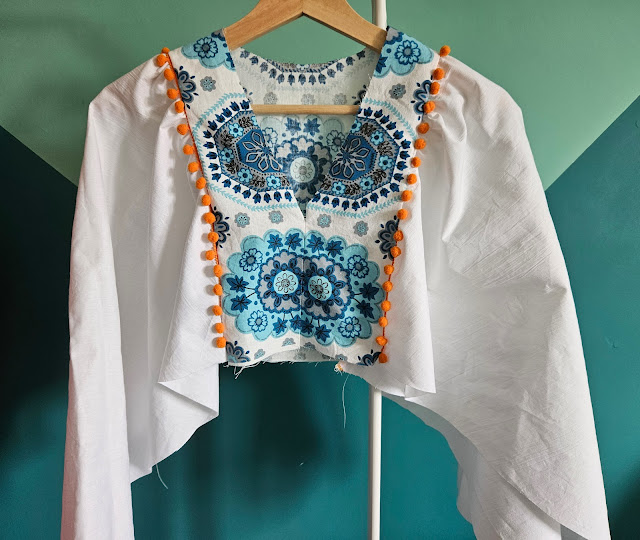 Top of the dress in white, turquoise and orange