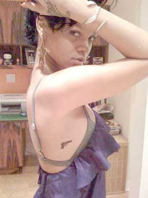 under the gun tattoo. house Rihanna#39;s gun tattoos