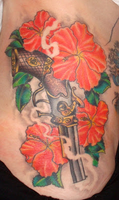 hibicus tattoo,  gun tattoo