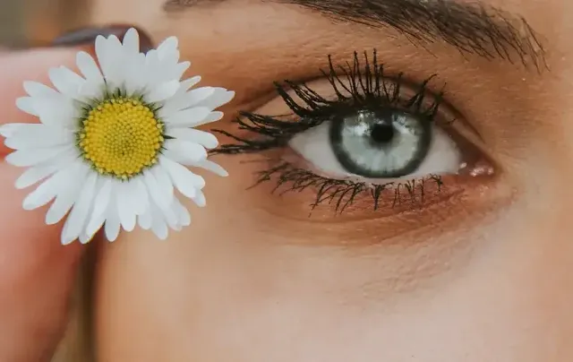 A Girl with Flower near Her Eye