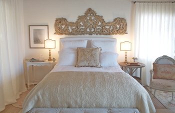 Romantic farmhouse European inspired bedroom with architectural element above bed by Giannetti Home
