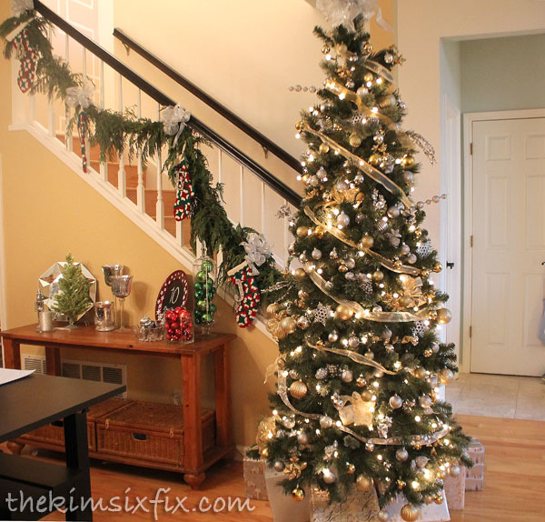 Christmas tree at base of stairs