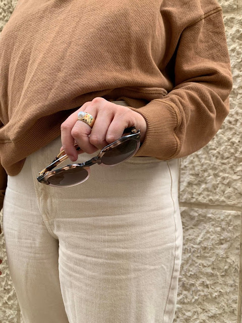 sunglasses and a gold and pearl ring