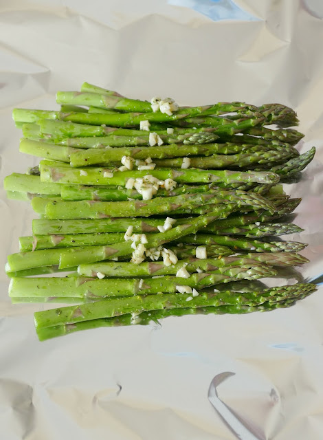 This side dish is simple to make on the grill or in the oven! It combines easy ingredients like asparagus, cheese, garlic, butter and seasonings for a mouthwatering side to go with chicken, beef, fish, seafood or pork! Great as a meatless meal too!