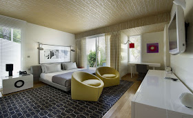 Another bedroom with modern interior design and two yellow chairs