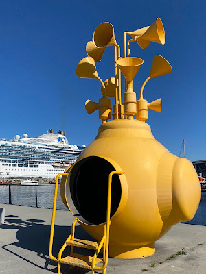 yellow submarine sculpture near cruise ship in Trondheim, Norway