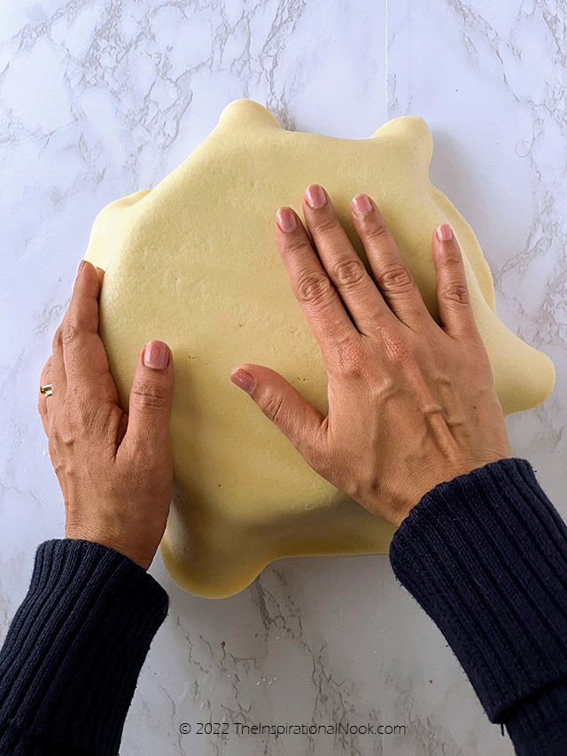how to apply ready rolled marzipan, how to cover round cake with ready rolled marzipan, smoothing marzipan with hands