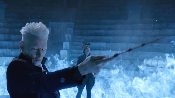 Grindelwald is pointing his wand to someone in blue colour background.