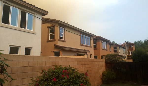 The smoke cloud from the Bobcat Fire lurks above other recently-built 2-story homes behind my backyard in Pomona, California...on September 9, 2020.