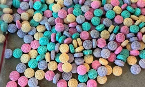 Brightly colored counterfeit M30 oxycodone pills.