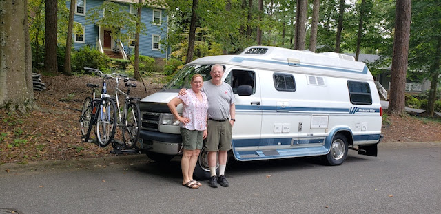 Woman and man standing in front of a camper van.