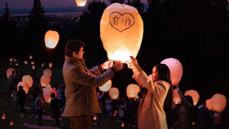 Lara Jean and Peter lighting lantern