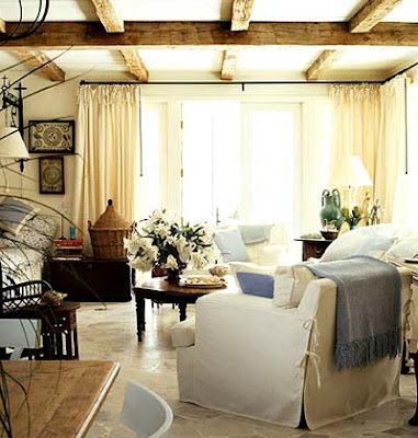 Love the distressed beams and the natural cream colored draperies