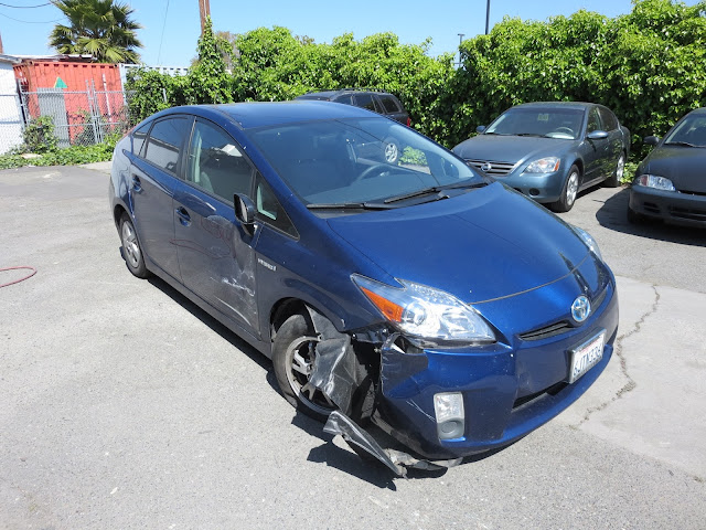 Prius with collision damage before repairs at Almost Everything Auto Body