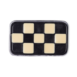 A rectangular black and white checkered flag designed soap on a bright background