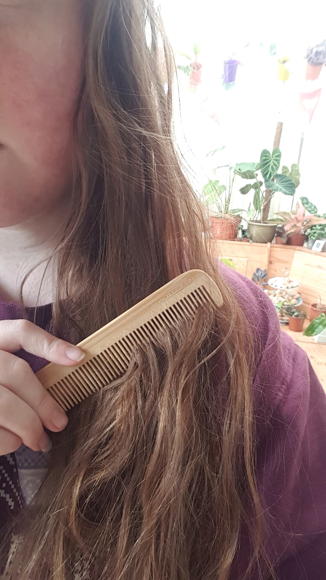 Zero Waste Club bamboo comb brushing through red wavy hair