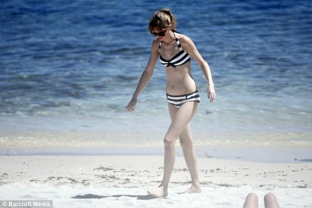 Taylor Swift channels 50s Barbie in a striped bikini