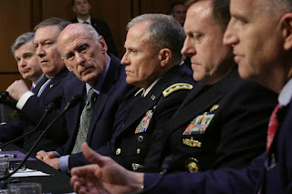 Intelligence officials testified before a Senate committee about global threats. Left to right: FBI Director Christopher Wray, CIA Director Mike Pompeo, National Intelligence Director Dan Coats, Defense Intelligence Agency Director Robert Ashley, National Security Agency Director Michael Rogers and National Geospatial Intelligence Agency Director Robert Cardillo. (Credit: Chip Somodevilla/Getty Images) Click to Enlarge.