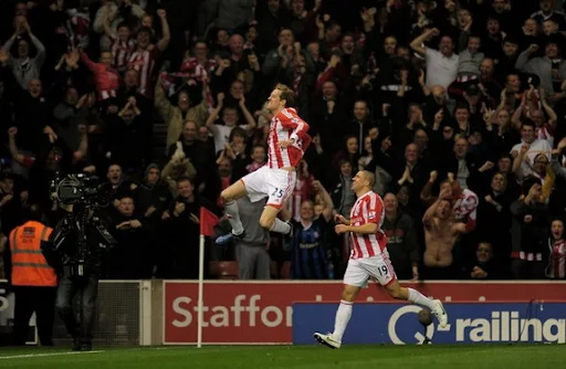 Peter Crouch celebrates with Stoke team-mate Jon Walters after scoring against Manchester City