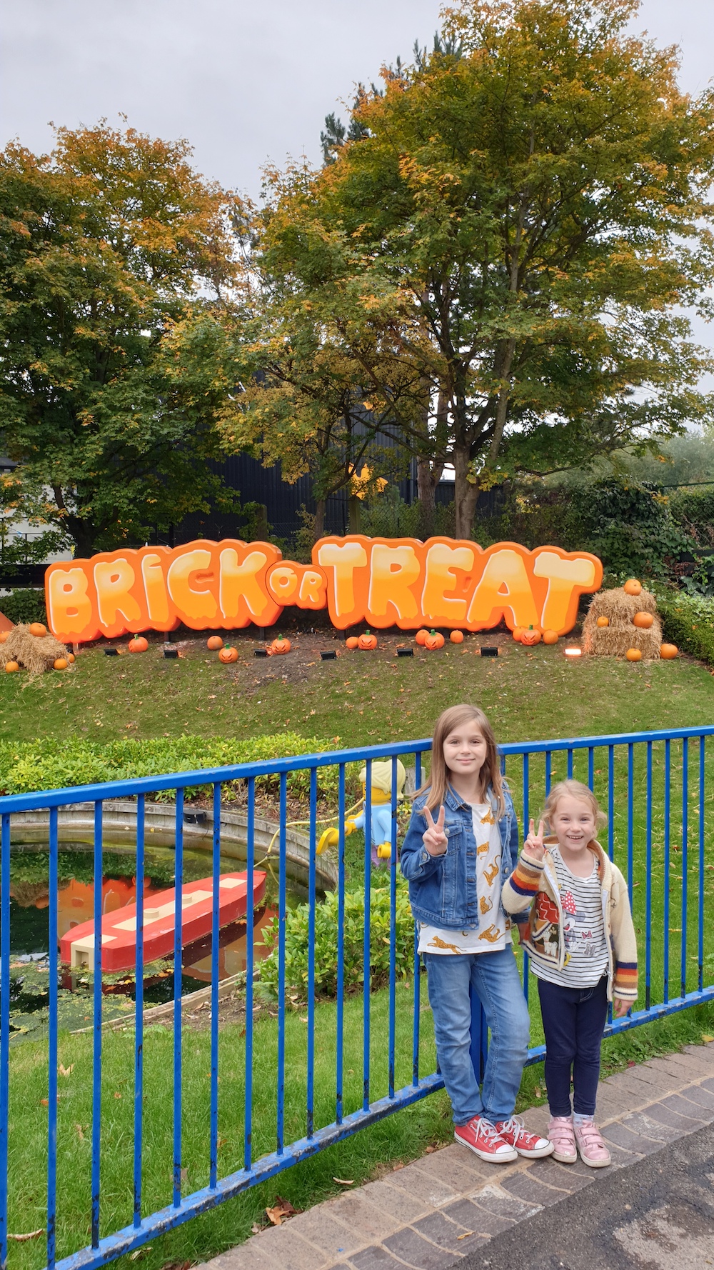 legoland brick or treat sign with kids in front