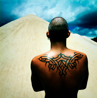 Triangle tribal tattoo on the back.