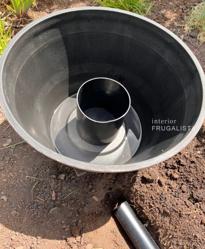 Set piece of PVC pipe inside a resin barrel planter to raise the solar rechargeable water fountain pump.