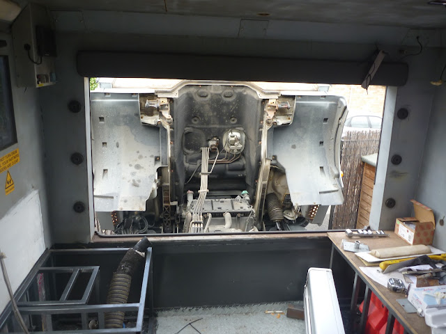 Looking towards the front of the box, with the cab tilted and the engine visible