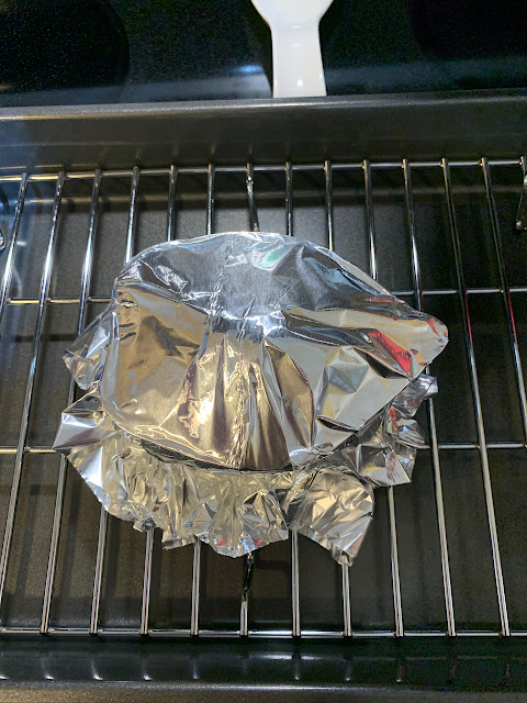 Squash covered with tinfoil on a roasting rack