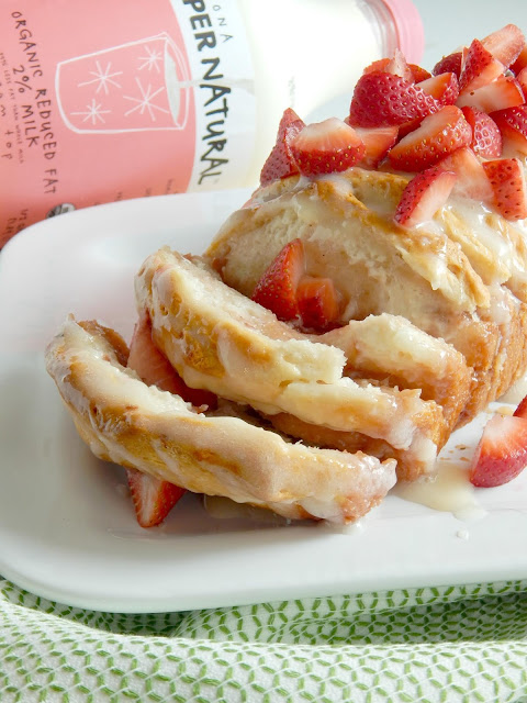 Strawberries & Cream Pull-a-Part Bread...a delicious breakfast treat!  Tender, flaky biscuits layered with cream cheese and strawberry jam, then drizzled with thick icing and topped with fresh strawberries!  Ideal for brunches, weekend breakfasts and party desserts.  Sponsored by Kalona SuperNatural. (sweetandsavoryfood.com)