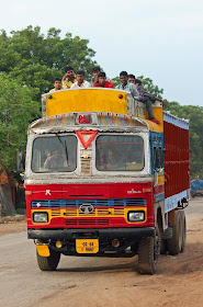 People riding atop a truck