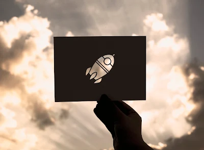 Hand hold a rocket paper