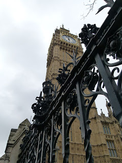 The Elizabeth Tower or Big Ben, a tall clock tower seen from below a fence, Westminster, London