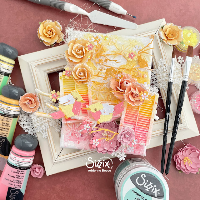 Mixed media canvas created with acrylic paint made to mimic watercolors, Sizzix Painted Bird and Woodland Cardfront Dies, and Prima Marketing flowers.