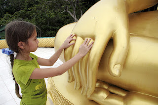 My daughter fascinated by the Buddhas hand