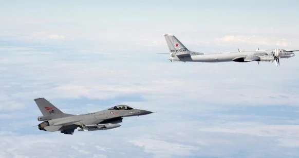 F-16 fighter jet following a Russian Tu-95 strategic bomber